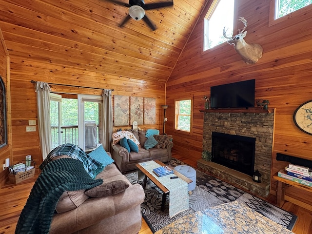 275 Walkers Rdg, Murphy, NC 28906 - living room featuring wooden walls, wood finished floors, a fireplace, high vaulted ceiling, and ceiling fan