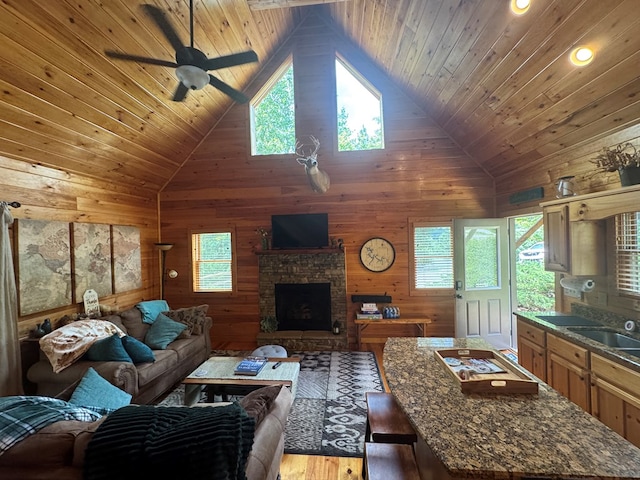 275 Walkers Rdg, Murphy, NC 28906 - living area with wooden ceiling, healthy amount of natural light, wooden walls, light wood finished floors, and a stone fireplace