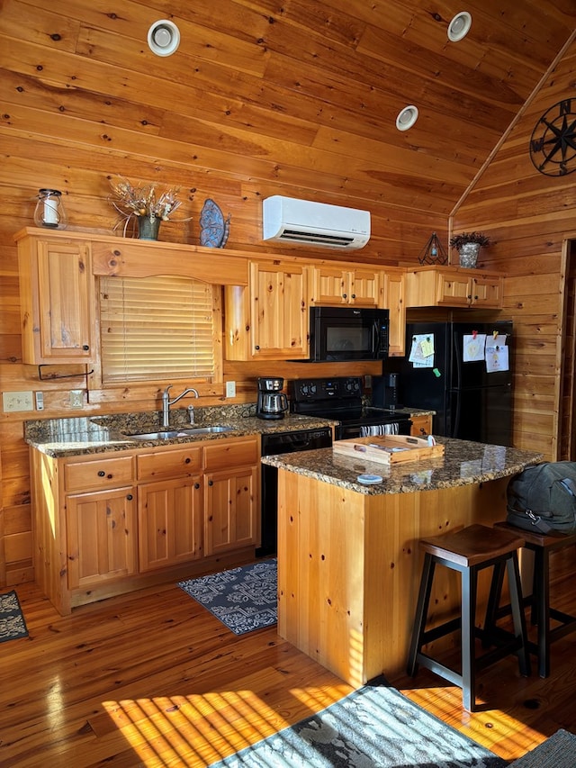 kitchen featuring wooden ceiling, a sink, black appliances, a wall unit AC, and lofted ceiling