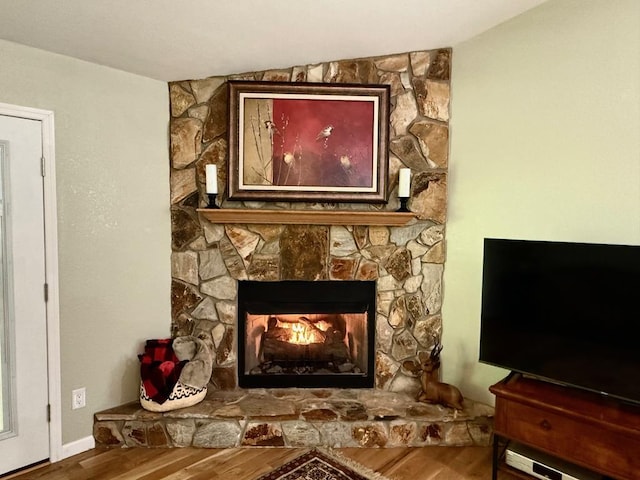 detailed view of wood finished floors and a fireplace