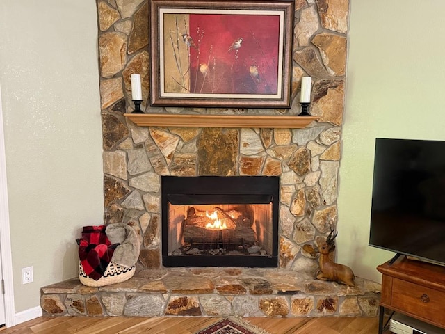detailed view of wood finished floors and a fireplace