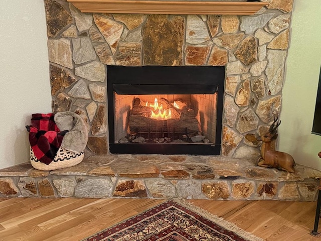 detailed view of a fireplace and wood finished floors