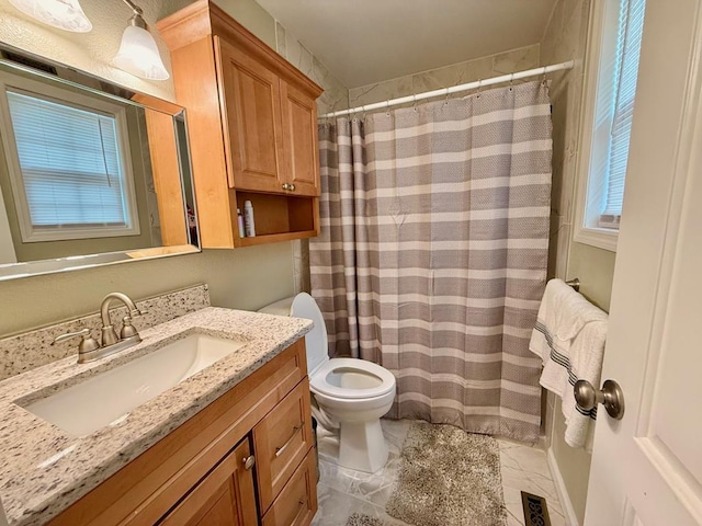 bathroom with toilet, vanity, and a shower with curtain