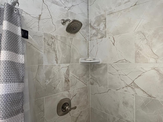 bathroom with tiled shower