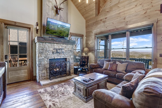 living area with high vaulted ceiling, wooden ceiling, a fireplace, and hardwood / wood-style flooring