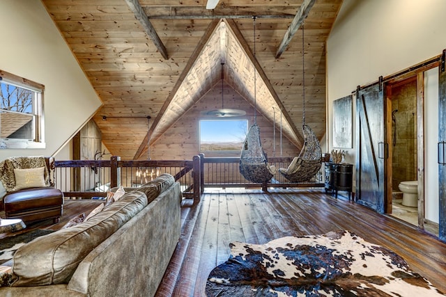 interior space featuring beamed ceiling, wood ceiling, a barn door, hardwood / wood-style flooring, and high vaulted ceiling