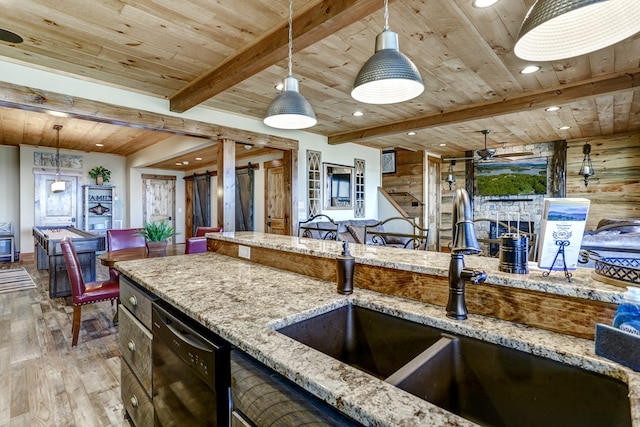 kitchen featuring a barn door, black dishwasher, wood ceiling, and a sink