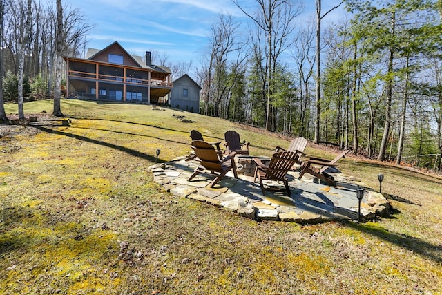 view of yard with a patio area, a fire pit, and a sunroom