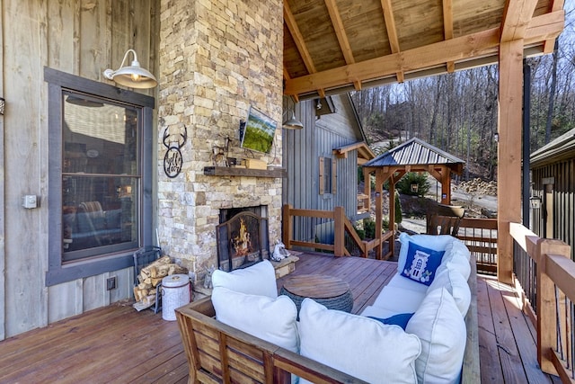 deck featuring a gazebo and an outdoor living space with a fireplace