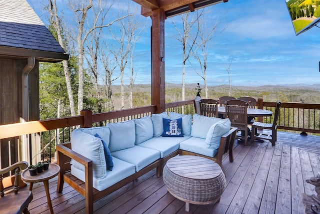 deck featuring outdoor dining area and an outdoor hangout area