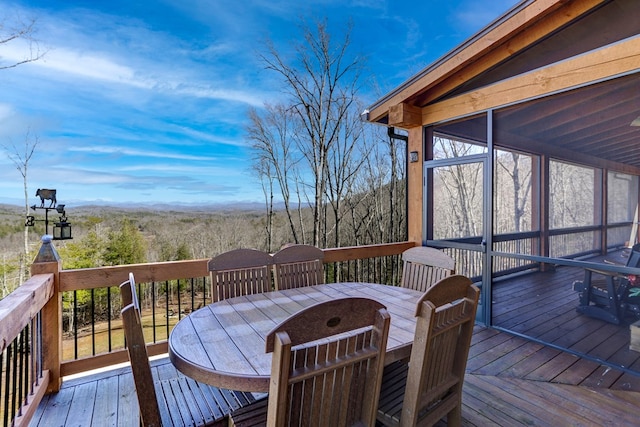 wooden terrace with outdoor dining space