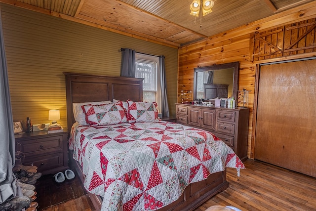 bedroom featuring wood-type flooring, wooden ceiling, and wood walls