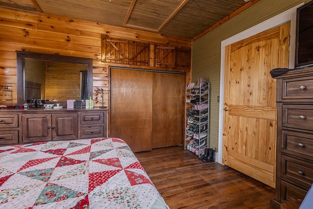 bedroom featuring wooden ceiling, dark hardwood / wood-style flooring, a closet, and wood walls