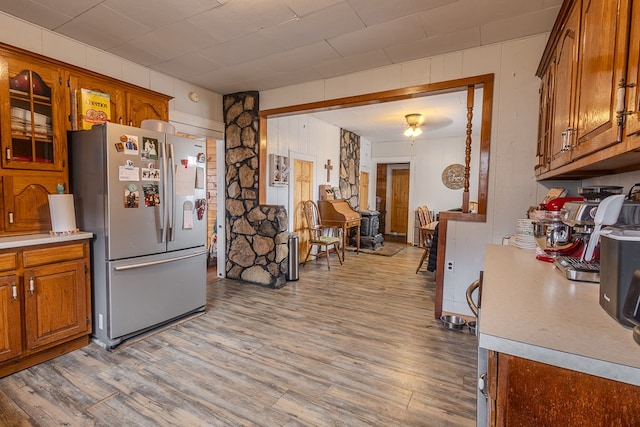 kitchen featuring stainless steel refrigerator and light hardwood / wood-style floors