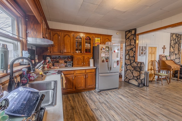 kitchen featuring sink, hardwood / wood-style flooring, and stainless steel refrigerator