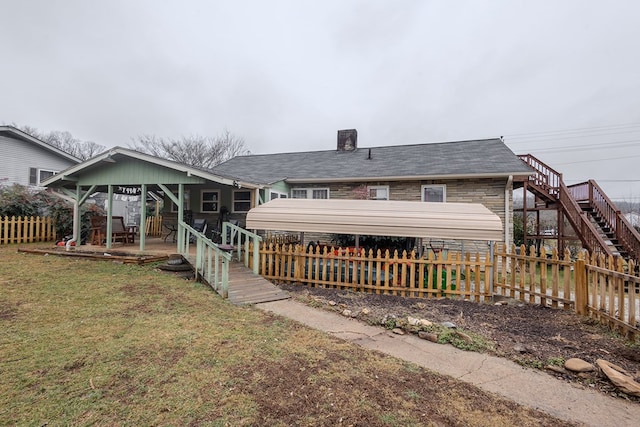 back of house with a lawn