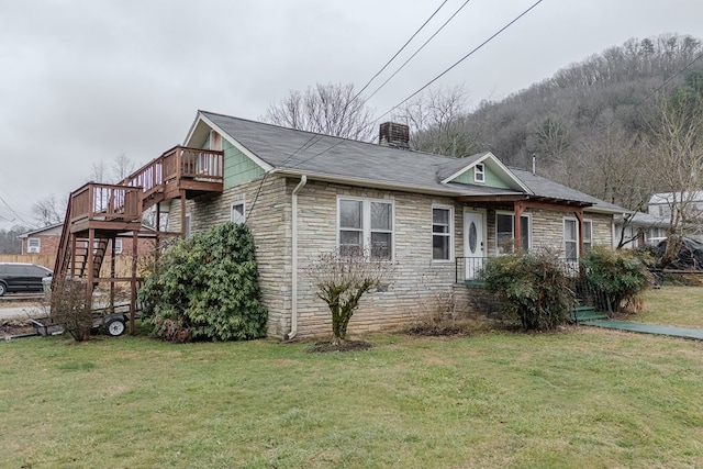 view of home's exterior featuring a lawn, central air condition unit, and a deck