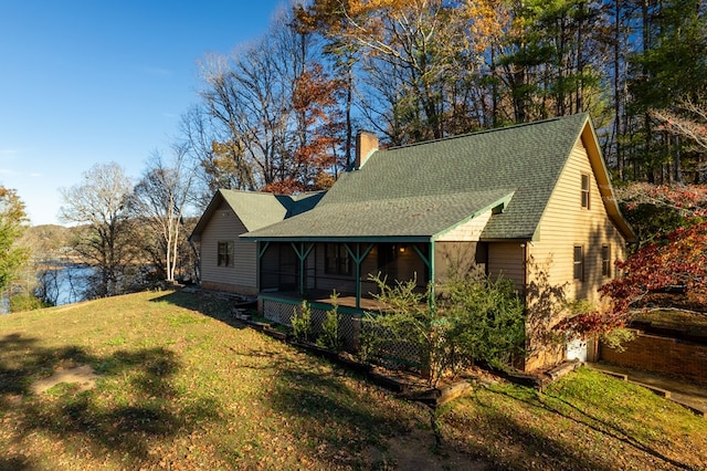 back of property featuring a lawn