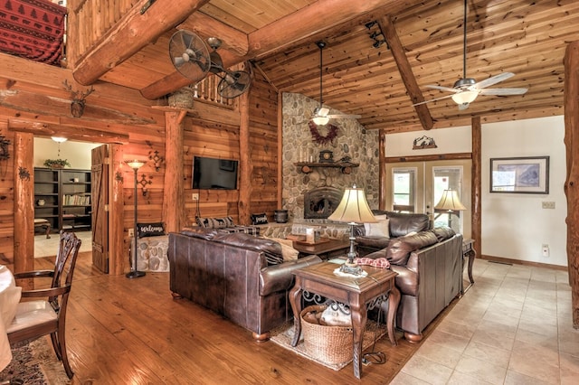 living room with light wood-type flooring, beam ceiling, ceiling fan, and high vaulted ceiling