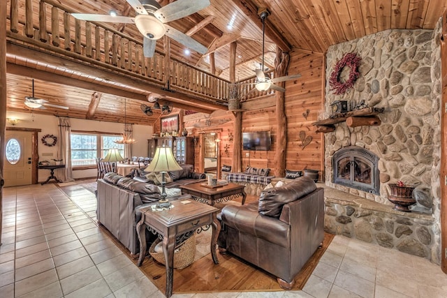 tiled living room with ceiling fan, wood ceiling, a fireplace, and wood walls