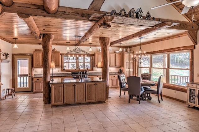 kitchen with dark stone countertops, pendant lighting, ceiling fan with notable chandelier, and wood ceiling