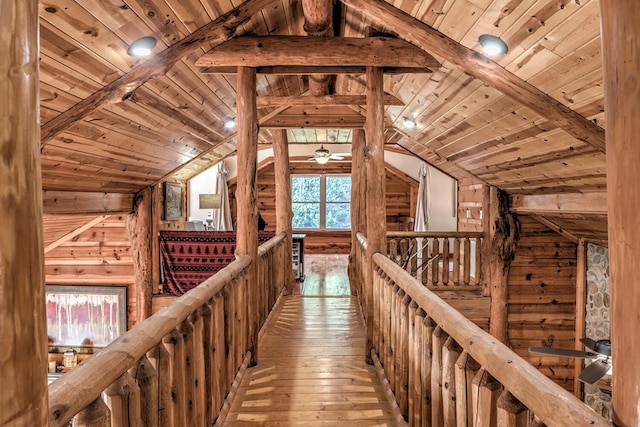 interior space featuring vaulted ceiling with beams, a healthy amount of sunlight, and light hardwood / wood-style flooring