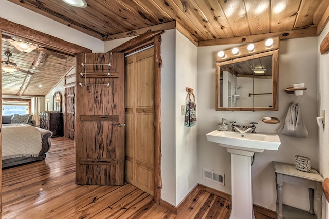 bathroom with wood-type flooring, wood ceiling, vaulted ceiling, and ceiling fan