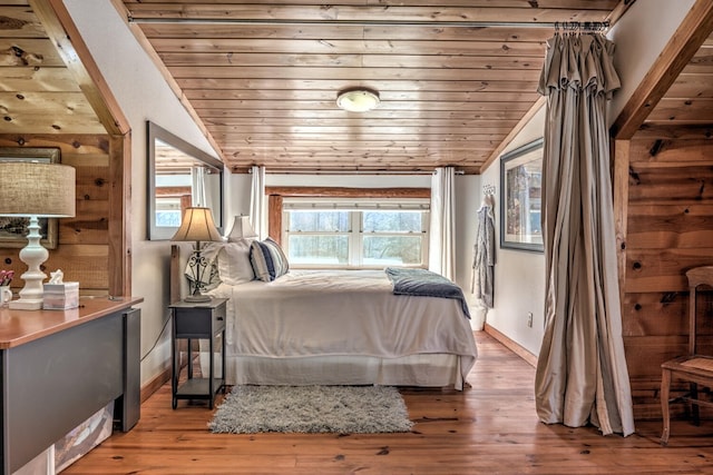 bedroom with wooden ceiling, vaulted ceiling, and hardwood / wood-style flooring