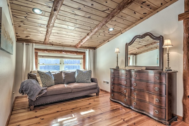 living room featuring vaulted ceiling with beams, light hardwood / wood-style floors, and wooden ceiling