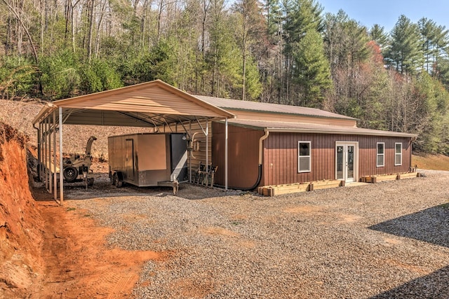 back of house with a carport