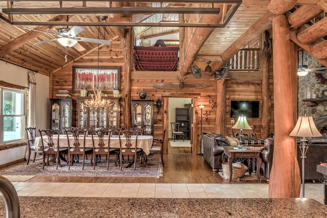 dining area featuring ceiling fan with notable chandelier, wood ceiling, beam ceiling, and hardwood / wood-style flooring