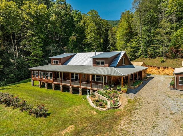 farmhouse featuring a front lawn and a porch