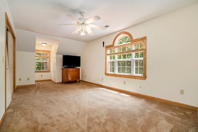 unfurnished living room with light carpet, lofted ceiling, and ceiling fan