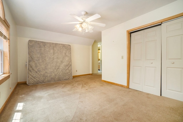 unfurnished bedroom featuring light colored carpet, a closet, and ceiling fan