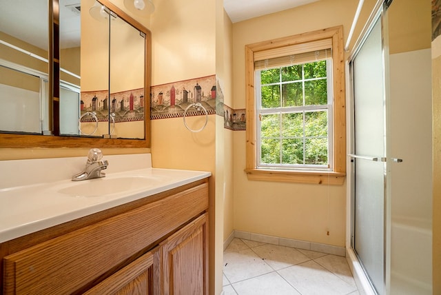 bathroom with vanity, a shower with shower door, and tile patterned flooring