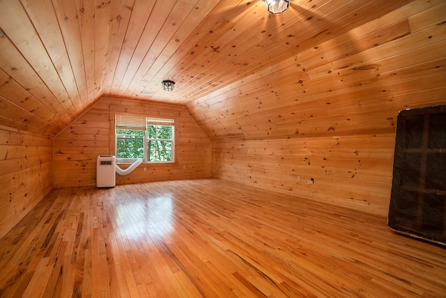 bonus room with lofted ceiling, wooden ceiling, light wood-type flooring, and wood walls