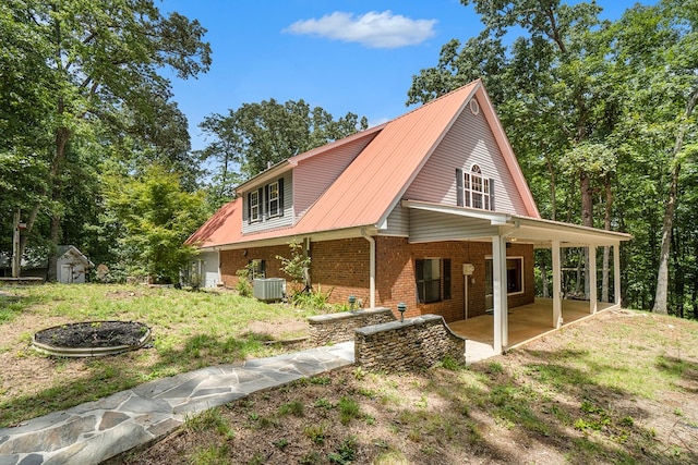 view of side of home featuring a storage shed, central AC, and a patio area