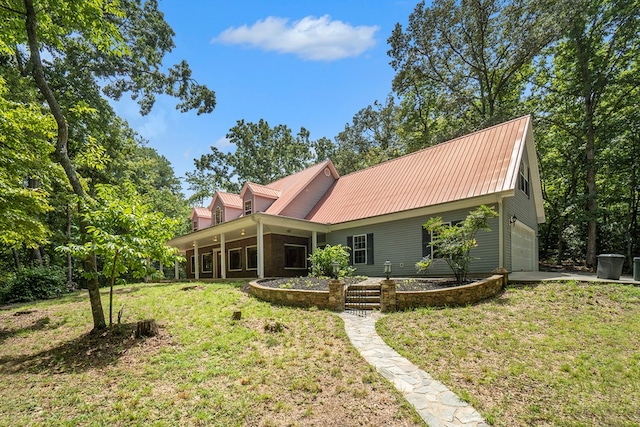 back of property with a yard and a garage