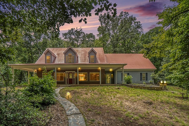 view of front of house with a yard and a porch