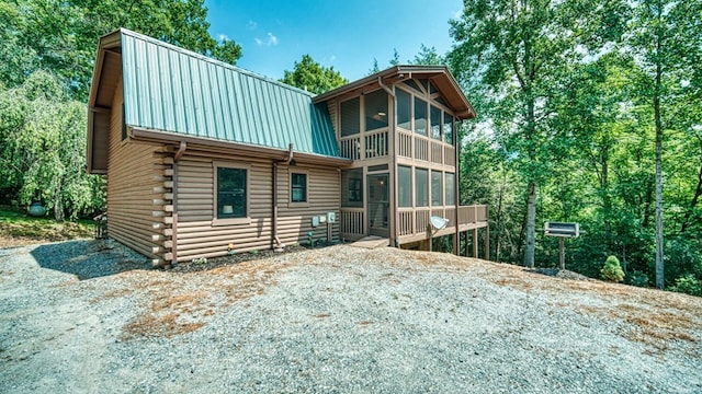 rear view of property with a sunroom