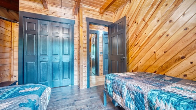 bedroom with wooden ceiling, a closet, and wood walls