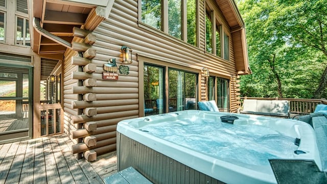 wooden deck featuring a hot tub