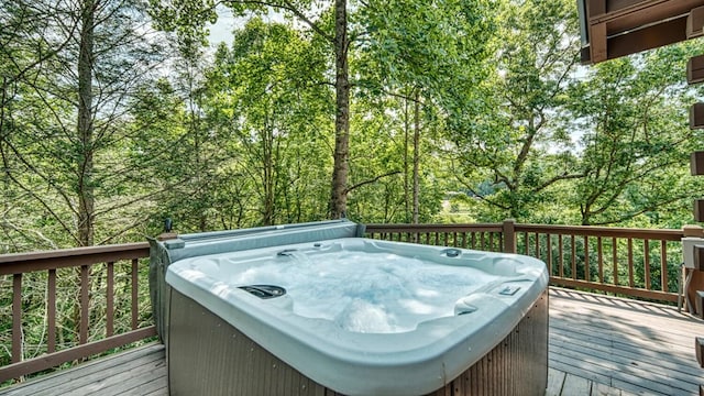 wooden terrace featuring a hot tub