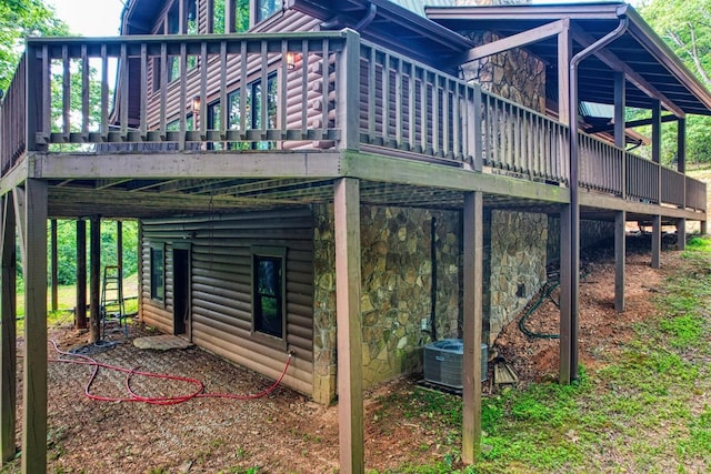 view of home's exterior with a deck and cooling unit