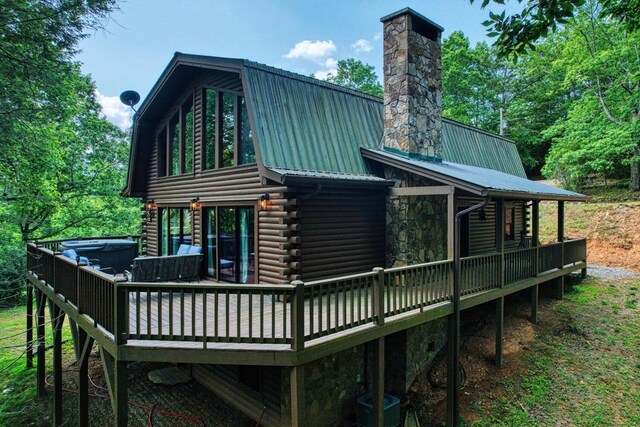 rear view of property with a wooden deck and central AC