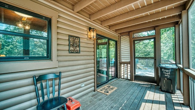 unfurnished sunroom featuring beam ceiling and wooden ceiling