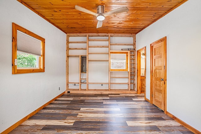 spare room featuring wooden ceiling, wood finished floors, a ceiling fan, and baseboards