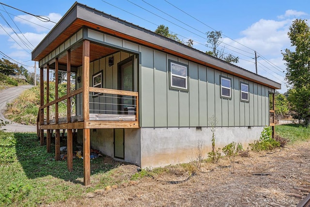 view of side of home with crawl space and board and batten siding