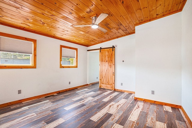 spare room with a barn door, baseboards, wooden ceiling, wood finished floors, and crown molding