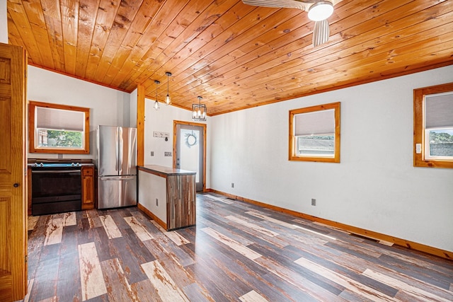 kitchen featuring a peninsula, dark wood-type flooring, black range with electric cooktop, and freestanding refrigerator